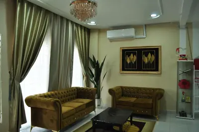 a living room with a couch and a table at Uwais Homestay Segari Lumut in Lumut