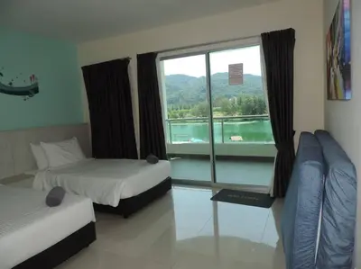 a room with two beds and a window with a view at Marina Island Seaview Homestay in Lumut