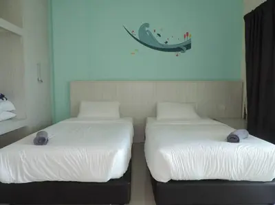 two beds sitting next to each other in a room at Marina Island Seaview Homestay in Lumut