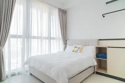 a bedroom with a bed and a large window at Urban Suite By Bold@Seaview in Jelutong