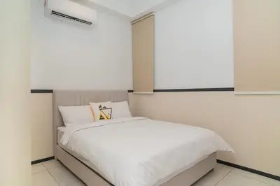a bedroom with a bed with white sheets at Urban Suite By Bold@Seaview in Jelutong