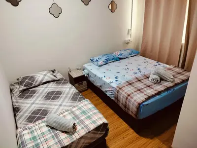 two beds in a small room with two bedsskirts at Idea Homestay 2 in Ipoh