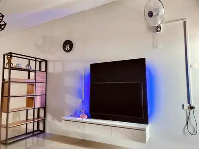 a living room with a large flat screen tv on a wall at Idea Homestay 2 in Ipoh