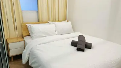 a white bed with a hat on top of it at Noordin ClanJetties Komtar Heritage Studio - E in George Town