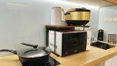 a kitchen counter with a pan on top of a microwave at Noordin ClanJetties Komtar Heritage Studio - E in George Town