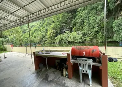 a patio with a sink and a table with a view at KT’s Lake House in Ipoh