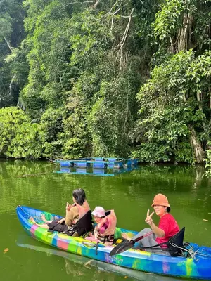 a group of people in a boat on a river at KT’s Lake House in Ipoh