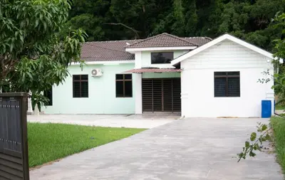 a white house with a garage at KT’s Lake House in Ipoh