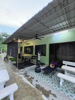 a building with a patio with benches and a grill at KT’s Lake House in Ipoh