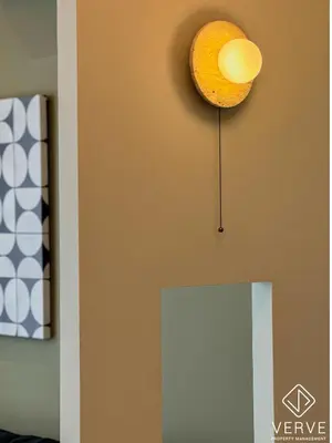 a light fixture on a wall next to a mirror at Ipoh Town Anderson Suites 4-6 pax by Verve in Ipoh