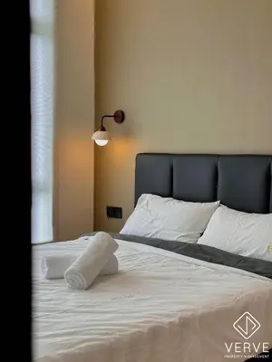 a bedroom with a bed with white sheets and a lamp at Ipoh Town Anderson Suites 4-6 pax by Verve in Ipoh