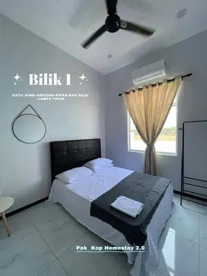 a bedroom with a bed and a ceiling fan at ISLAMIC Pak Kop Homestay with private pool 2 in Parit Buntar