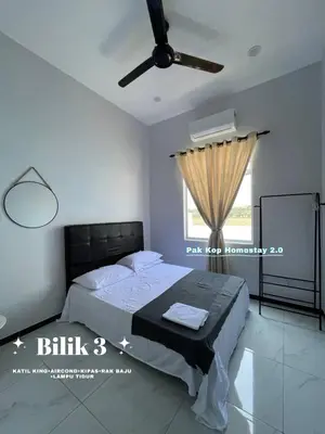 a bedroom with a bed and a ceiling fan at ISLAMIC Pak Kop Homestay with private pool 2 in Parit Buntar