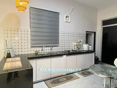 a kitchen with a sink and a window at ISLAMIC Pak Kop Homestay with private pool 2 in Parit Buntar