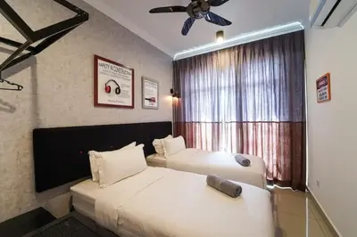 two beds in a hotel room with a window at SIDE CONTRUCTION MODERN DESIGN@THE MAJESTIC IPOH in Ipoh