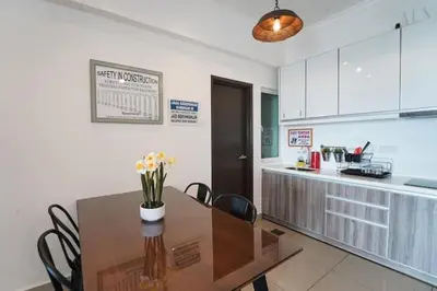 a kitchen with a table with chairs and a counter at SIDE CONTRUCTION MODERN DESIGN@THE MAJESTIC IPOH in Ipoh