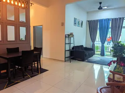 a living room with a table and a couch at IZZ Homestay MUSLiiM in Ipoh