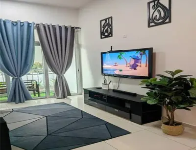 a living room with a flat screen tv and blue curtains at IZZ Homestay MUSLiiM in Ipoh