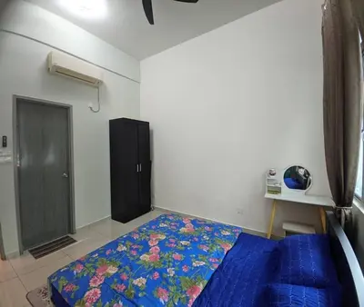 a bedroom with a blue bed and a black cabinet at IZZ Homestay MUSLiiM in Ipoh