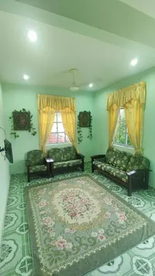 a living room with two couches and a large rug at Penang Green Homestay 1st Floor in Permatang Pauh