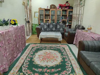 a living room with a couch and a rug at Penang Green Homestay 1st Floor in Permatang Pauh