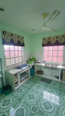 a kitchen with a green and white floor with windows at Penang Green Homestay 1st Floor in Permatang Pauh