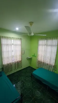 a room with a bed and two windows and a ceiling at Penang Green Homestay 1st Floor in Permatang Pauh