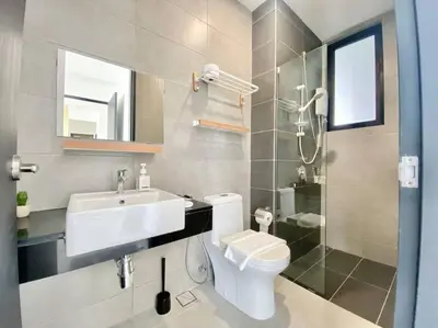 a bathroom with a toilet and a sink and a shower at Urban Suites #Creamy style #Infinity Pool #local neighbourhood #5pax #3BR 2bath #2Queen 1Single #Quality well maintained #Private host in Jelutong