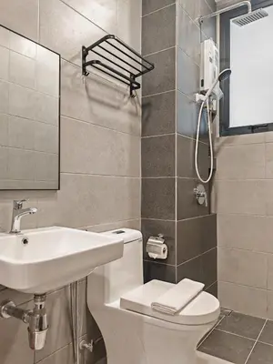 a bathroom with a sink and a toilet and a mirror at Modern Elegance - Urban Suites by Ocean Luxe in Jelutong