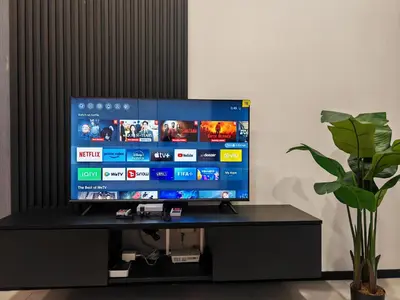 a flat screen tv sitting on top of a black stand at Modern Elegance - Urban Suites by Ocean Luxe in Jelutong