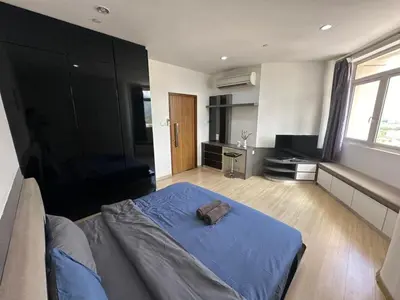 a bedroom with a blue bed in a room at Luxury Suites 118 Island Plaza in Tanjong Tokong