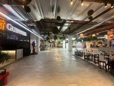 an empty hallway in a building with tables and chairs at Luxury Suites 118 Island Plaza in Tanjong Tokong