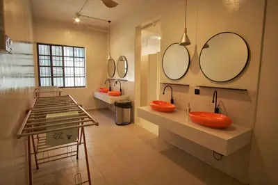 a bathroom with two sinks and two mirrors at Some Place Else in George Town