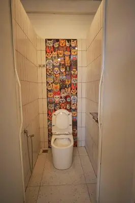 a small bathroom with a toilet in a stall at Some Place Else in George Town