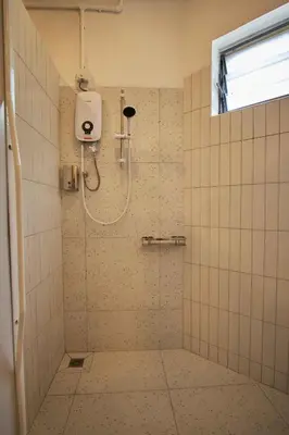 a shower stall in a bathroom with a window at Some Place Else in George Town