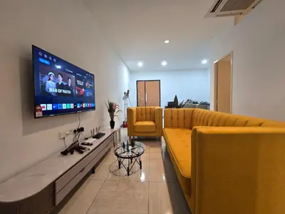 a living room with a couch and a flat screen tv at The Octagon Premium Suite - Ipoh in Ipoh