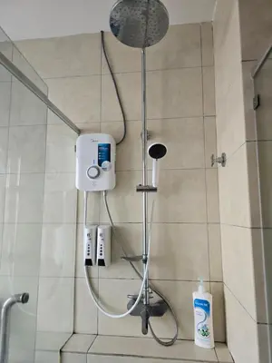 a shower with a shower head in a bathroom at The Octagon Premium Suite - Ipoh in Ipoh