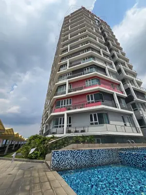 a tall building with a swimming pool in front of it at The Octagon Premium Suite - Ipoh in Ipoh