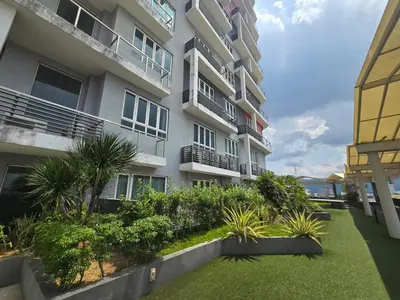 an apartment building with a garden in front of it at The Octagon Premium Suite - Ipoh in Ipoh