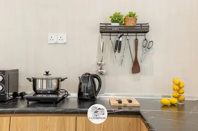 a kitchen with a counter with a pot and utensils at La Ferringhi Villa in Batu Ferringhi