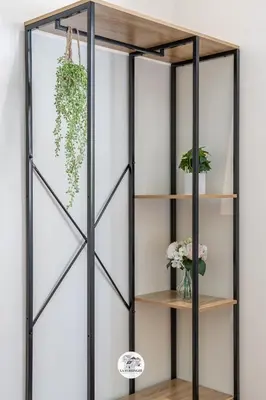 a glass partition with wooden shelves and plants at La Ferringhi Villa in Batu Ferringhi