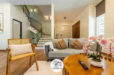 a living room with a couch and a table at La Ferringhi Villa in Batu Ferringhi