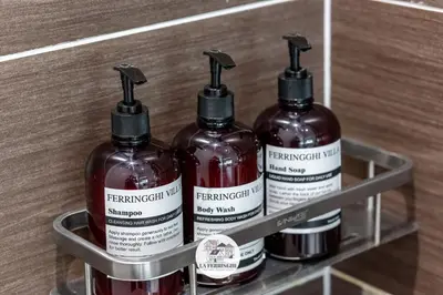 a shelf with three bottles on it in a store at La Ferringhi Villa in Batu Ferringhi