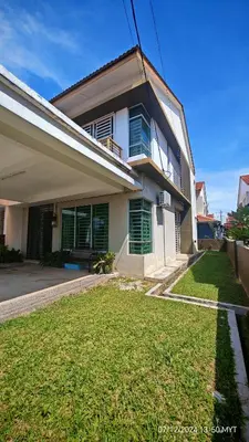 a house with a green lawn in front of it at Homestay Qasrina Semi D 4 Bilik in Kepala Batas