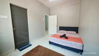 a bedroom with a bed with a black head board at Homestay Qasrina Semi D 4 Bilik in Kepala Batas