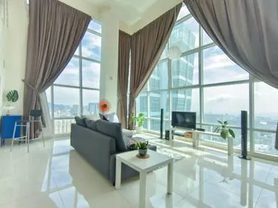 a living room with a couch and a table at Maritime Suite Penang - City & Sea view in George Town