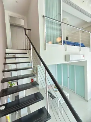 a spiral staircase in a house with a room at Maritime Suite Penang - City & Sea view in George Town