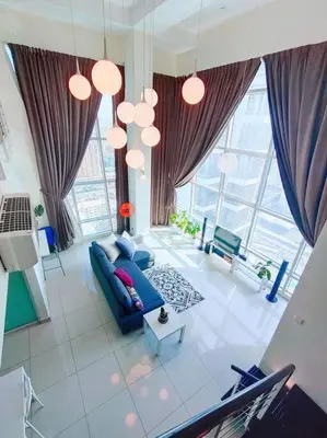 an overhead view of a living room with a blue couch at Maritime Suite Penang - City & Sea view in George Town