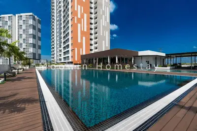 a large swimming pool in a city with tall buildings at Meritus Premium Home Suite 8 Pax in Perai