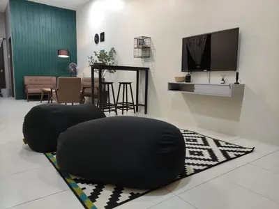 a living room with two bean chairs and a television at 32 Impian Homestay, Taiping in Taiping